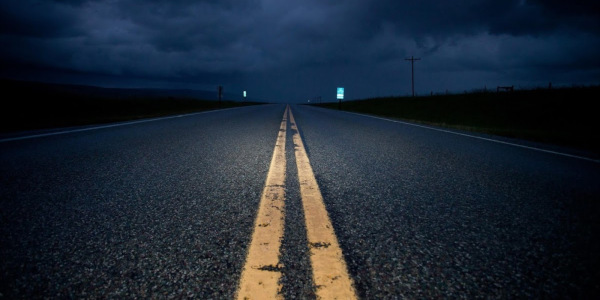 A lonely stretch of road at night.